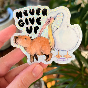 Never Give Up Capybara Pelican Holographic Glitter Vinyl Die Cut Durable Sticker