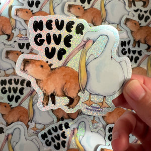 Never Give Up Capybara Pelican Holographic Glitter Vinyl Die Cut Durable Sticker